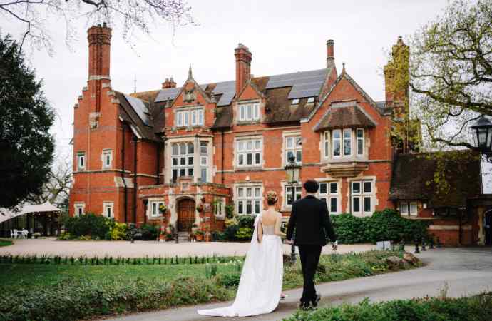spring wedding couple walking towards Berwick Lodge in Bristol