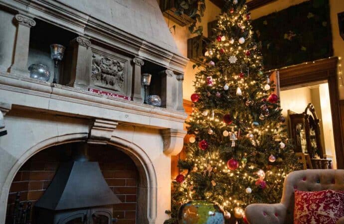Berwick Lodge reception in Bristol beautifully decorated for Christmas, featuring a glowing fireplace, festive Christmas tree, and elegant seasonal décor.