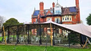 All-weather stretch tent set just outside Berwick Lodge Hotel, seamlessly connecting an outdoor wedding reception with a cosy, warm indoor lounge, perfect for celebrating in any season.